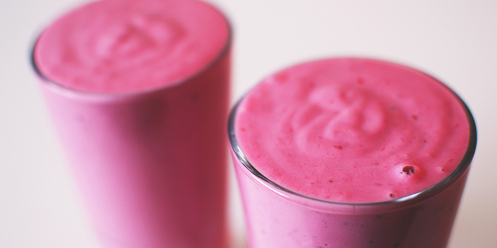 A raspberry smoothie in a glass.