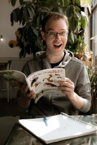A man reads Calvin and Hobbes.