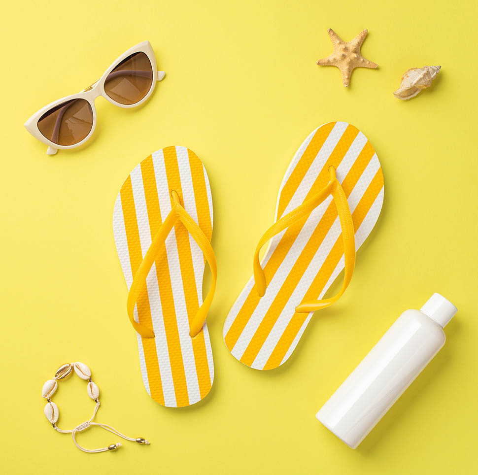 Yellow sunglasses, flip-flops and sunscreen